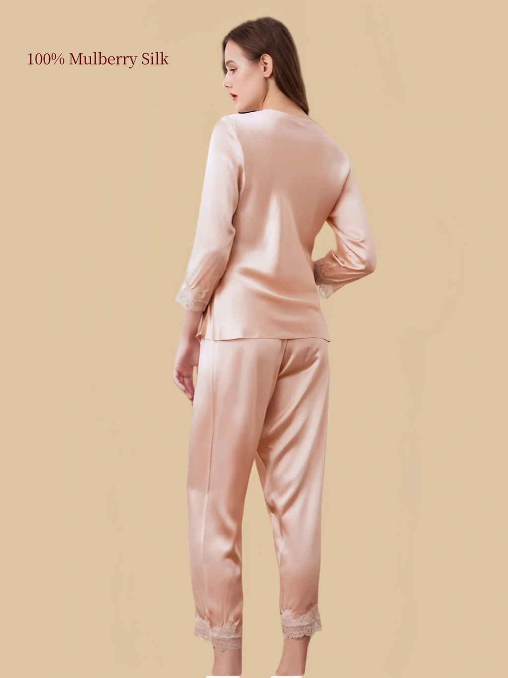 Back view of Dusty Apricot silk pajamas showing the smooth silk top, flowing drape and matching pants finished with floral lace.
