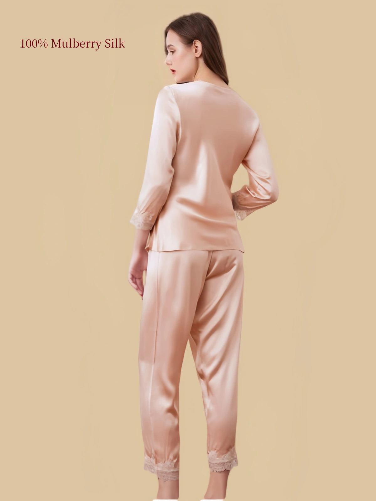 Back view of Dusty Apricot silk pajamas showing the smooth silk top, flowing drape and matching pants finished with floral lace.