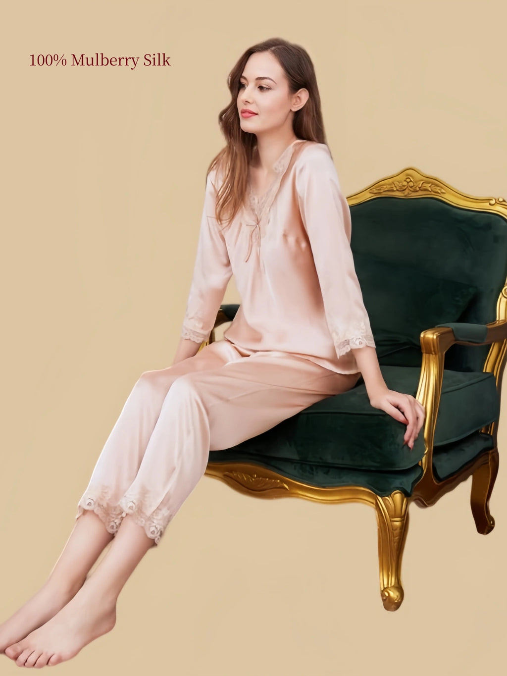 Model relaxing in Silkgala Dusty Apricot silk pajamas, highlighting the lace-trimmed V-neck, softly draped fabric and decorative pant hems.