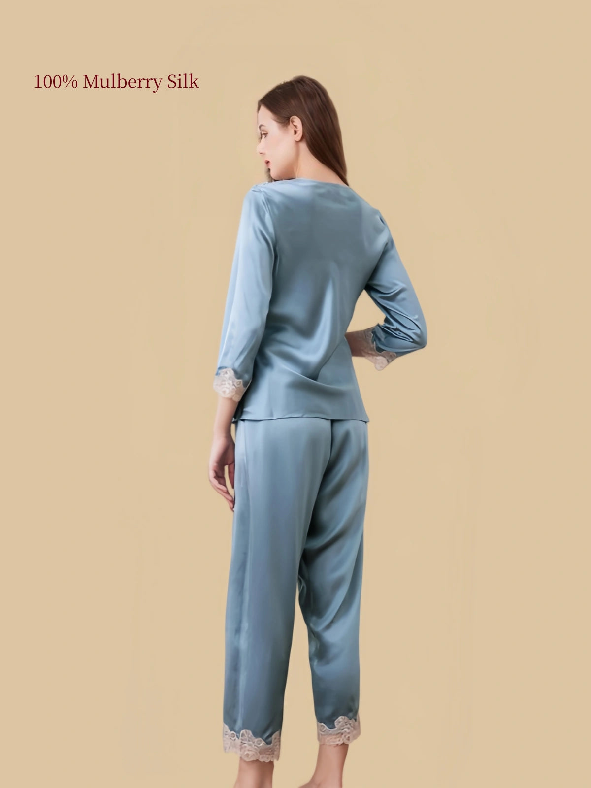 Back view of Silkgala Hazy Blue silk pajama set showing the smooth pullover top, softly draped pants and delicate floral lace hems.
