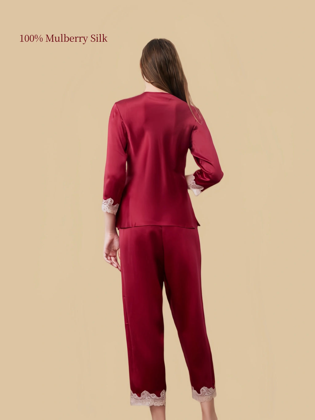 Back view of Silkgala Jujube Red silk pajama set showing the smooth pullover top and straight-leg pants with delicate floral lace hems.