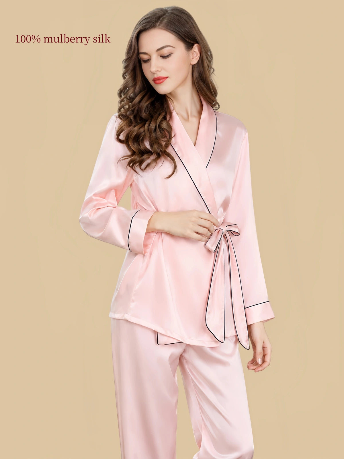 Front detail of Silkgala pink silk pajama top showing the shawl-style crossover neckline, matching waist tie and dark piping.