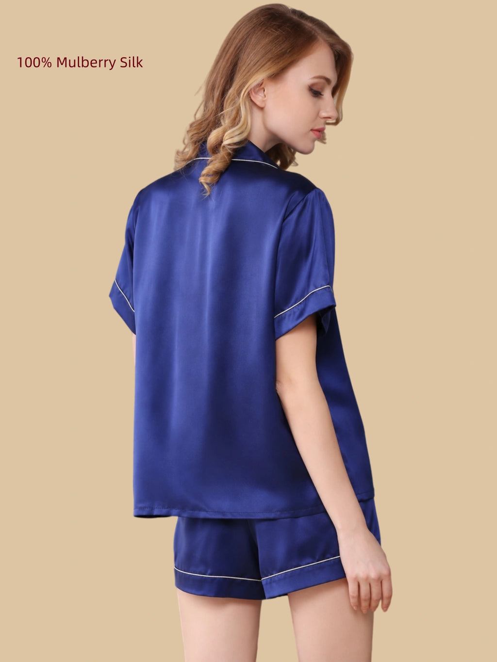 Back view of a Royal Blue 16 Momme mulberry silk shirt and shorts pajama set with contrast piping