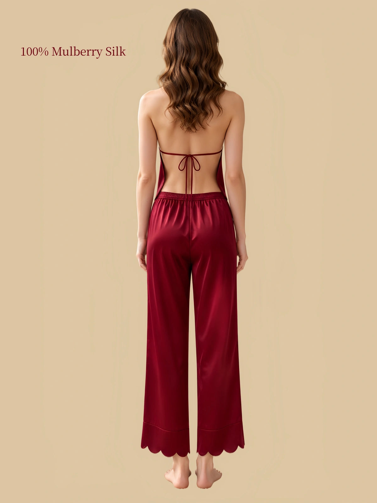 Rear view of Luxurious Red silk halter top and matching long pants with an elastic waistband and curved hems.