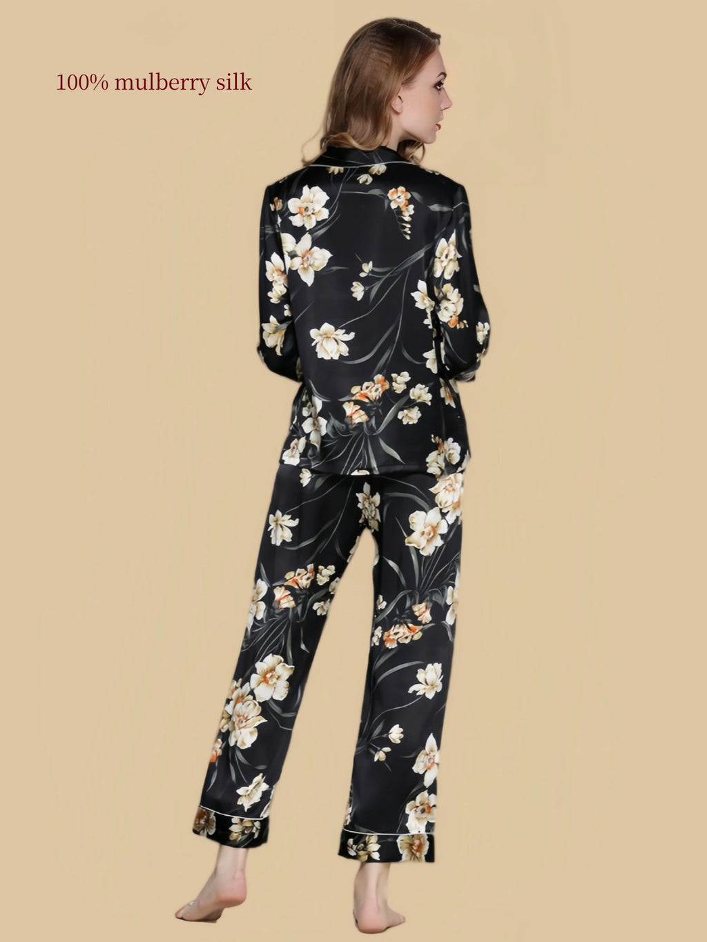 Back view of Silkgala black floral mulberry silk pajama set featuring botanical blossoms across the long-sleeve shirt and matching pants.