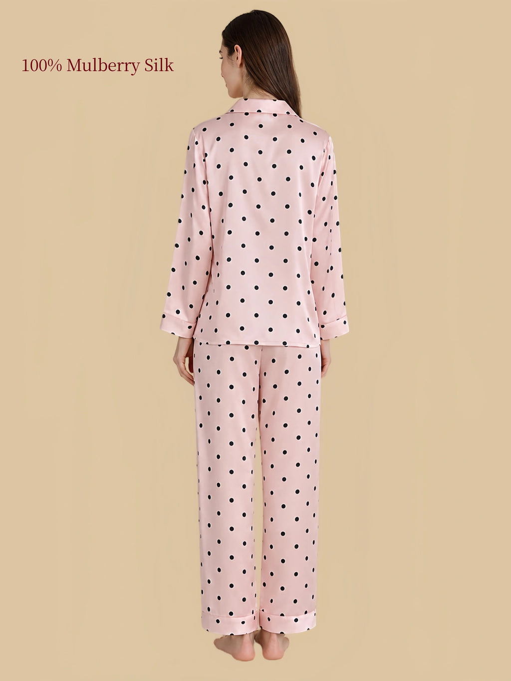 Back view of Silkgala pink polka dot silk pajamas showing black dots across the long-sleeve shirt and matching straight-leg pants.