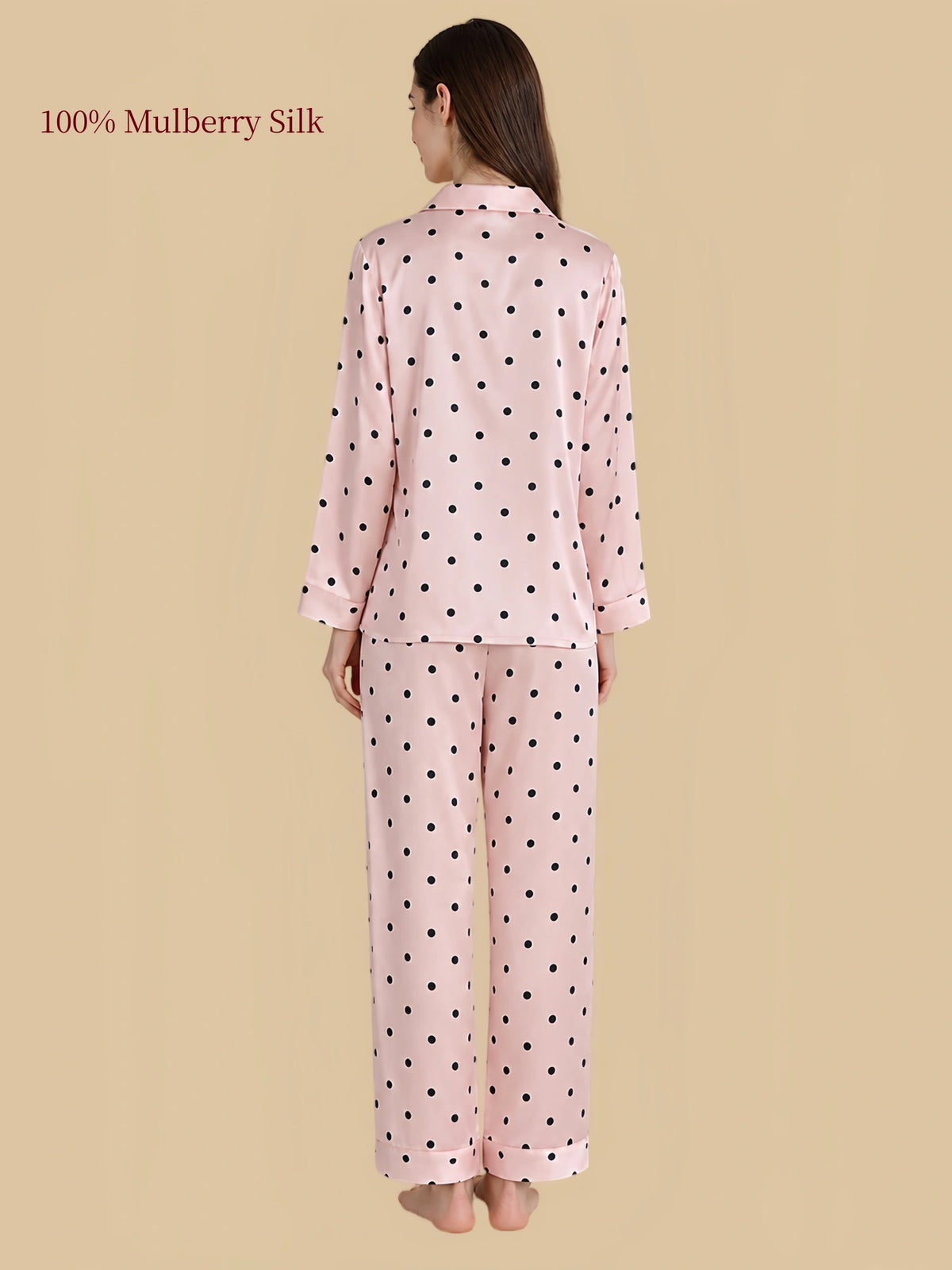 Back view of Silkgala pink polka dot silk pajamas showing black dots across the long-sleeve shirt and matching straight-leg pants.