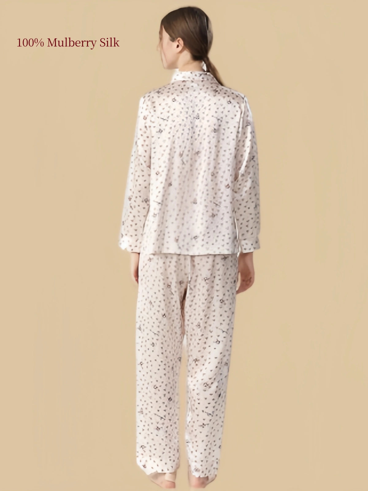 Back view of Silkgala Pale Blush Pink mulberry silk pajama set showing delicate heart and cat patterns across the long-sleeve shirt and matching pants.