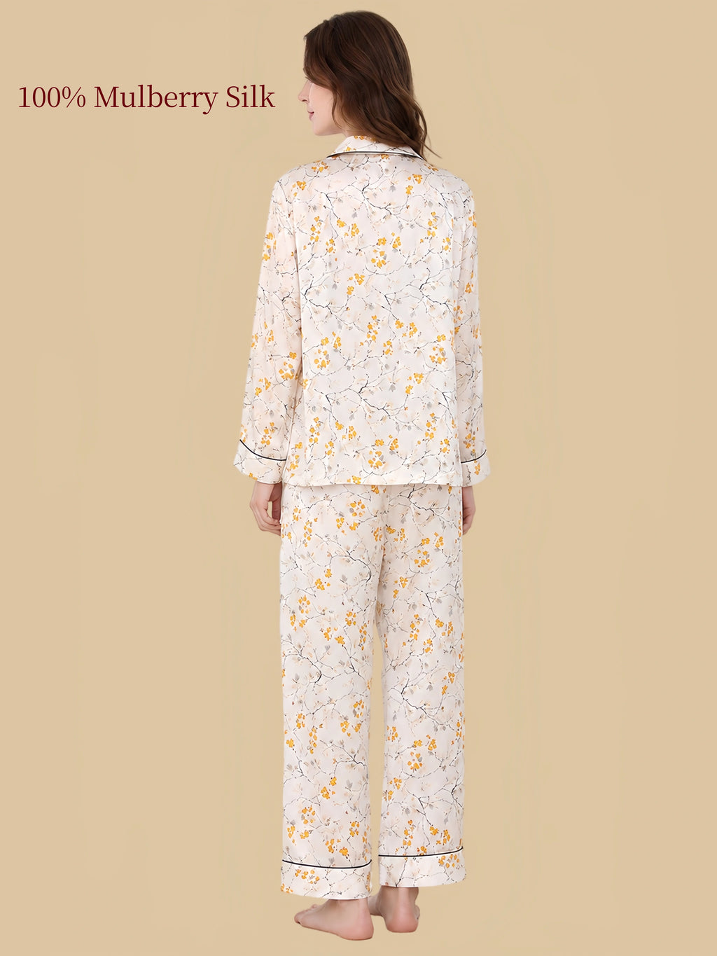 Back view of Silkgala ivory floral silk pajamas showing delicate yellow blossoms, fine branching patterns and black-piped cuffs and pant hems.