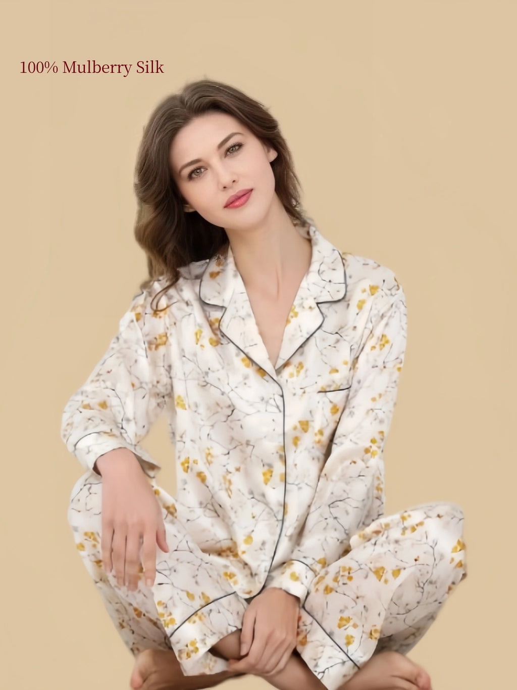 Model seated in Silkgala Ivory Yellow Floral silk pajamas, highlighting the relaxed wide-leg pants and soft drape of the long-sleeve set.