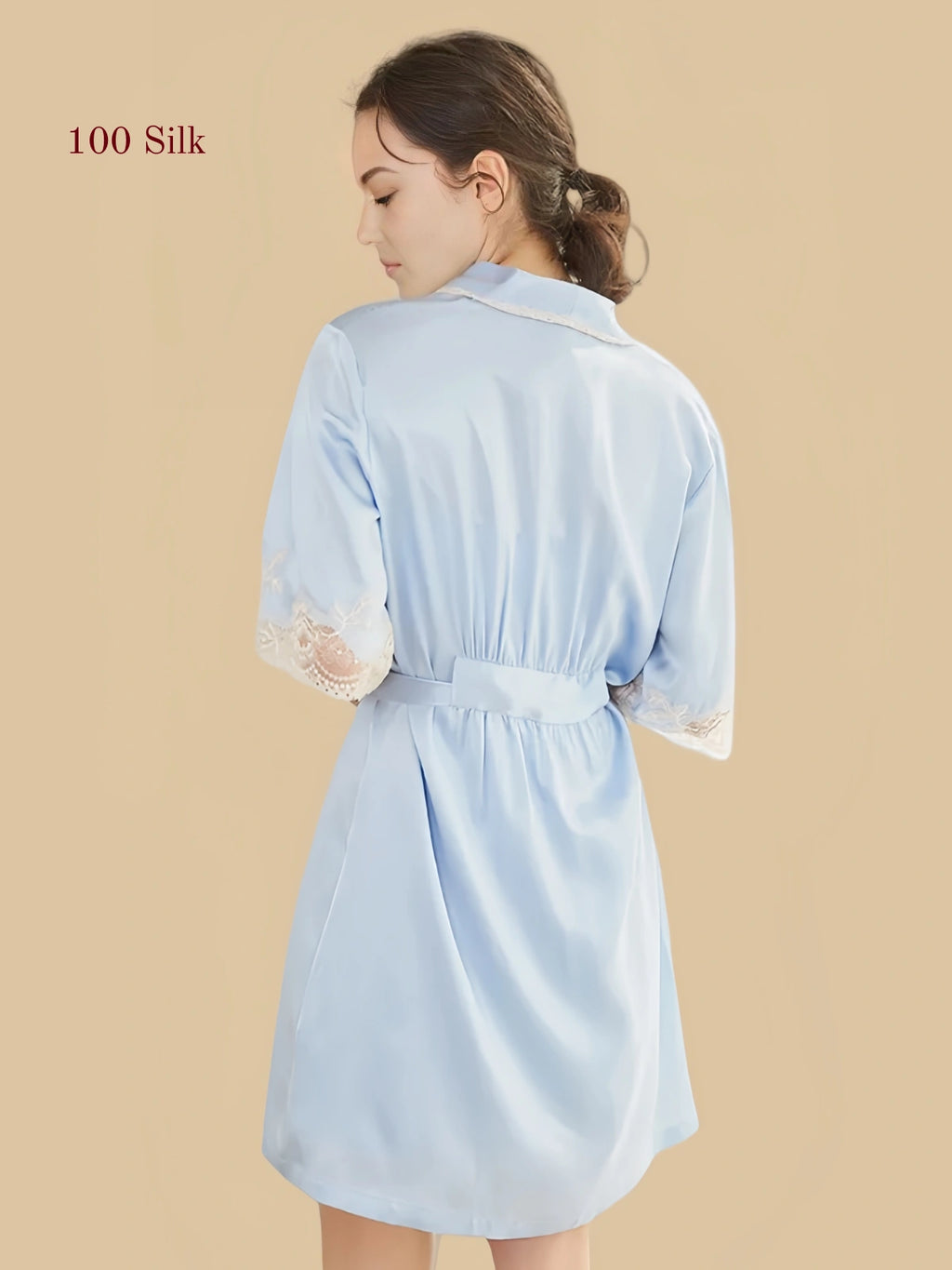 Back view of a light blue 19 Momme mulberry silk robe with lace cuffs and a tie waist