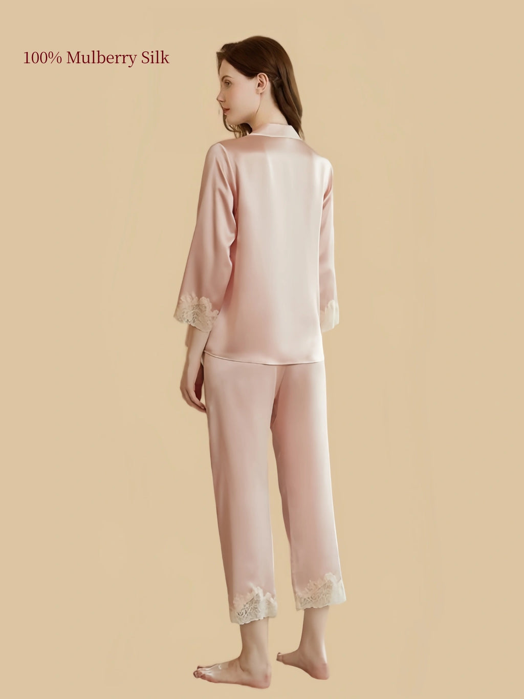 Back view of Silkgala Pink 19 Momme mulberry silk loungewear showing a smooth button-front shirt, three-quarter sleeves with lace cuffs and matching straight-leg pants.