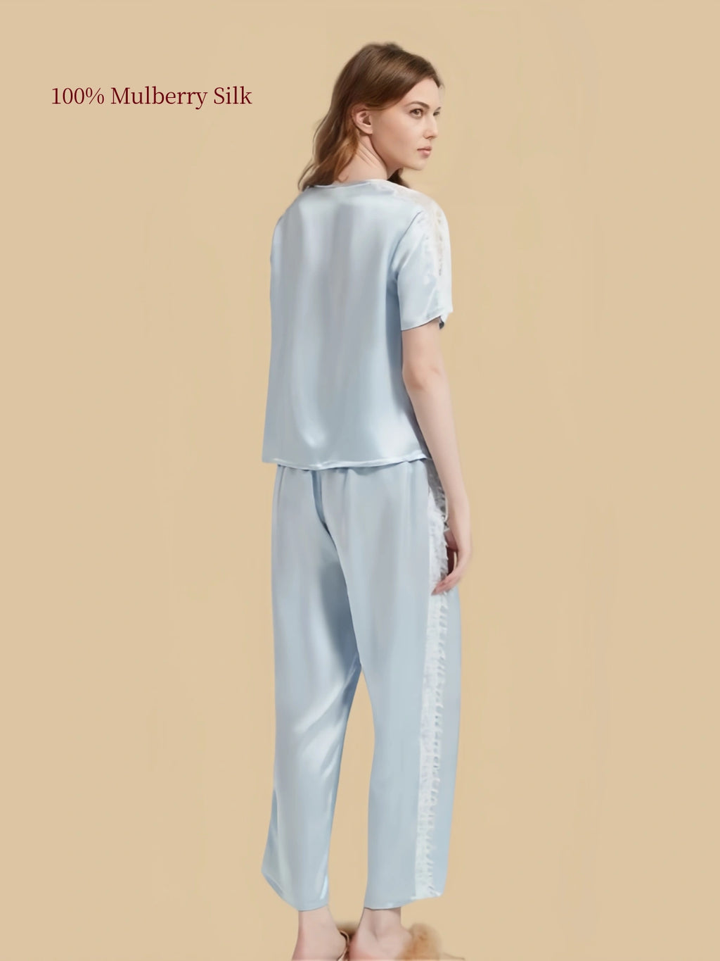 Back three-quarter view of Aqua Blue silk pajamas showing relaxed pullover top and lace detailing along outer pant legs