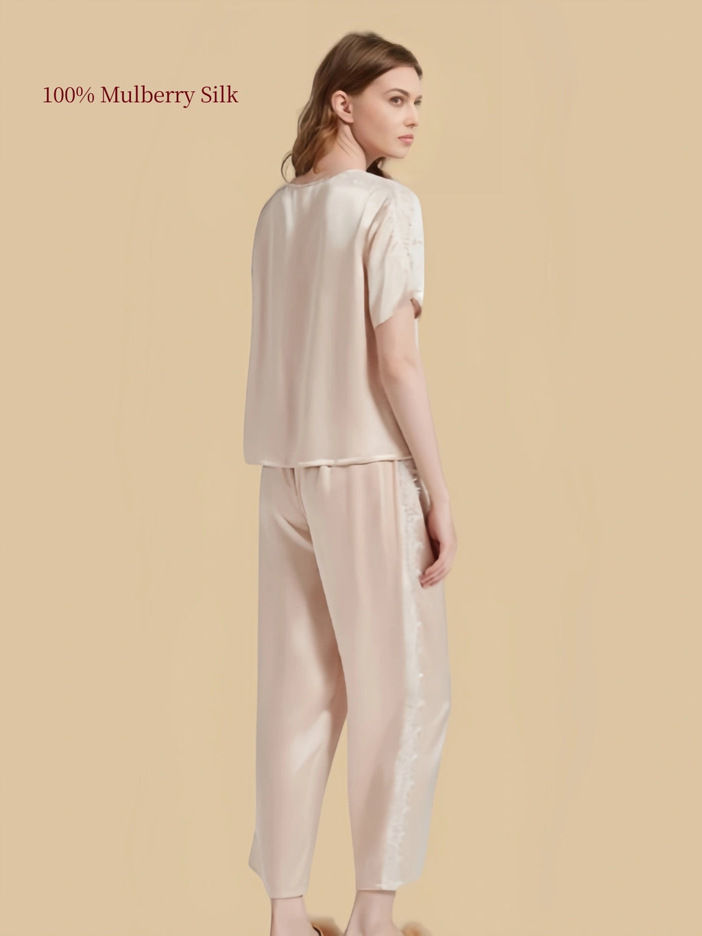Back three-quarter view of Light Apricot silk pajama set highlighting smooth silk fabric and outer leg lace inserts