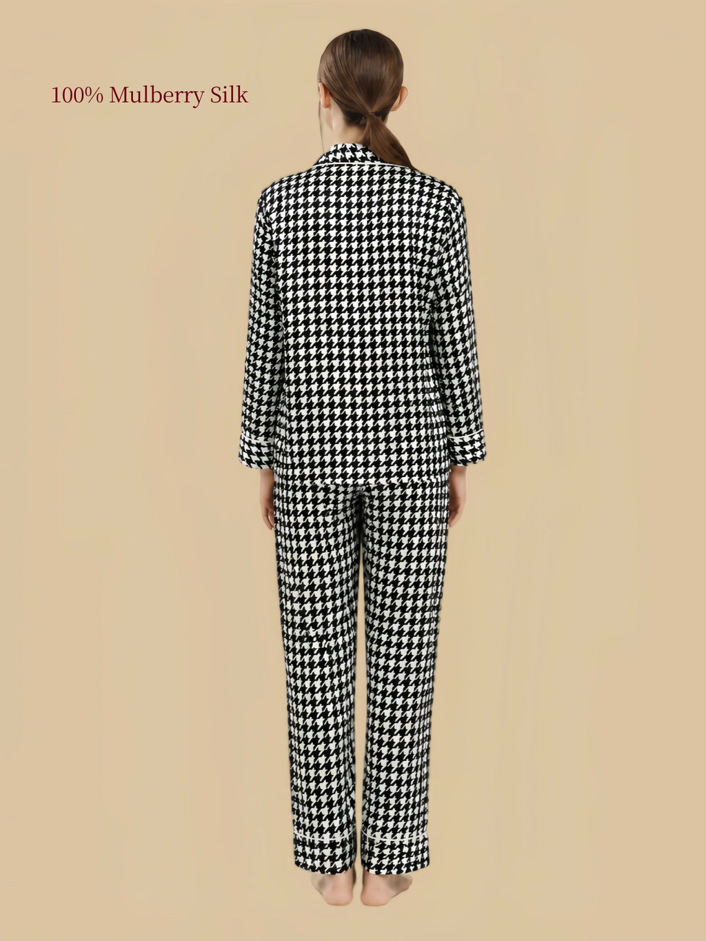 Back view of Silkgala 19 Momme mulberry silk pajama set in Black and White Houndstooth with long sleeves and straight-leg pants.