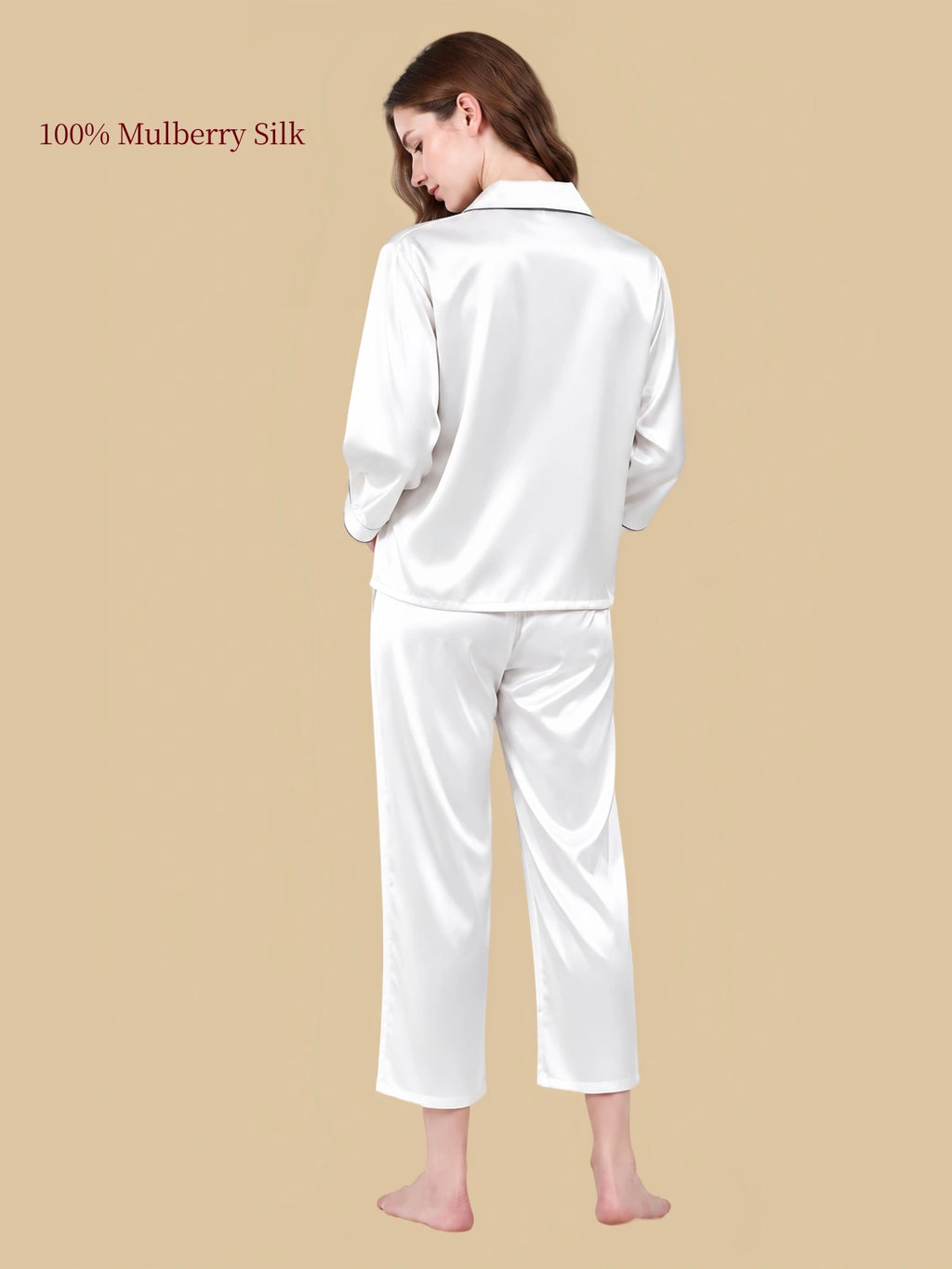 Back view of Pearl White silk sleepwear with three-quarter sleeves, relaxed pants and dark trim along the collar.