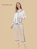 White mulberry silk pajama set with black contrast braided trim, two front patch pockets and a notched collar.