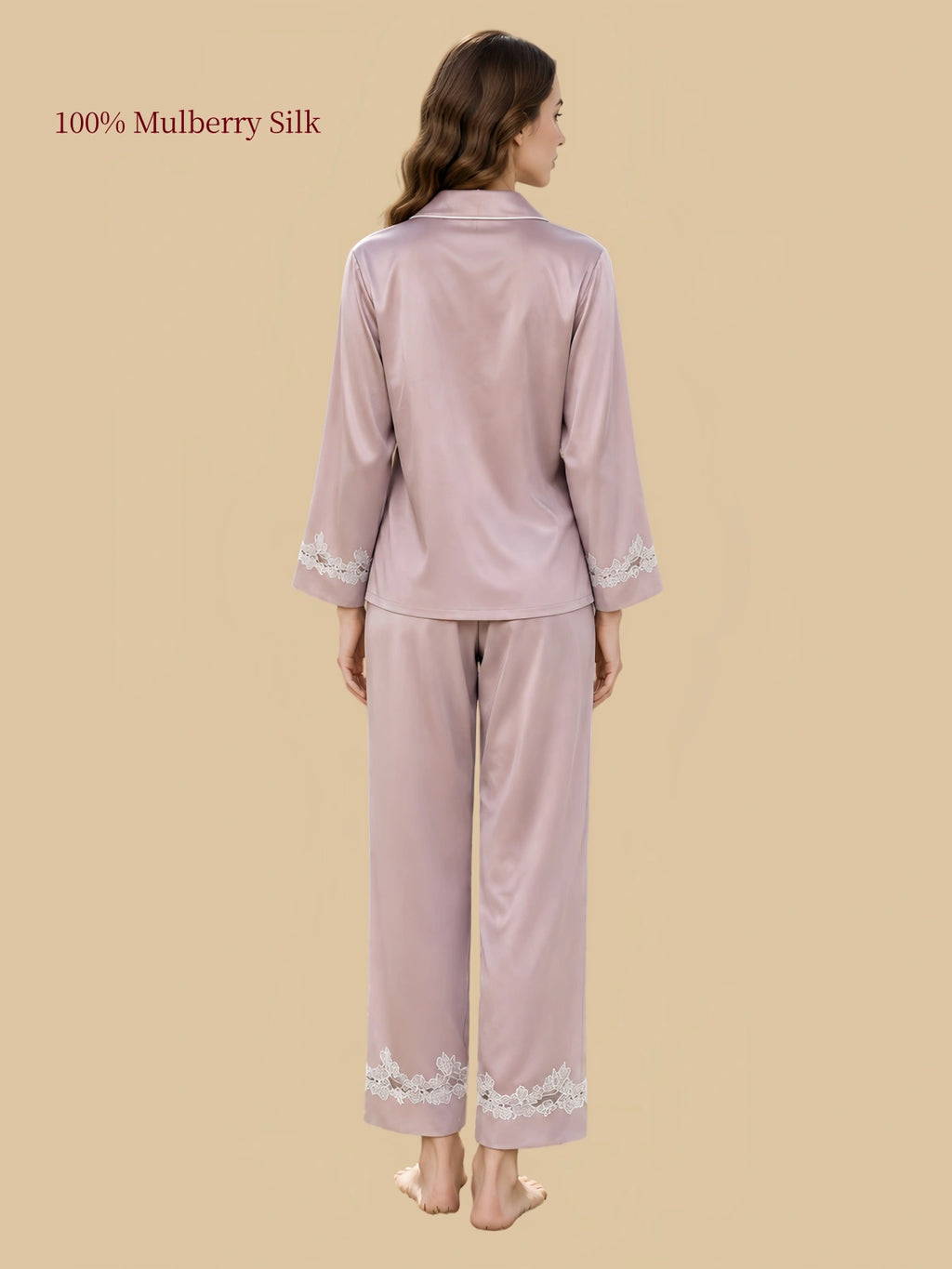 Back view of Cherry Blossom Pink silk pajamas showing the long-sleeve shirt, relaxed pants and light floral lace along the cuffs and hems.