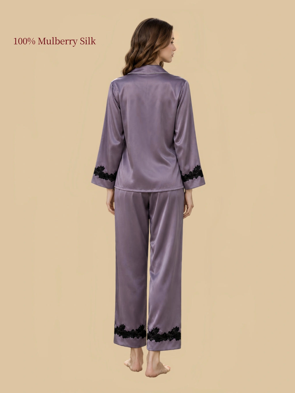 Back view of Twilight Purple silk sleepwear with relaxed long sleeves, straight-leg pants and black floral lace trim along the cuffs and pant hems.