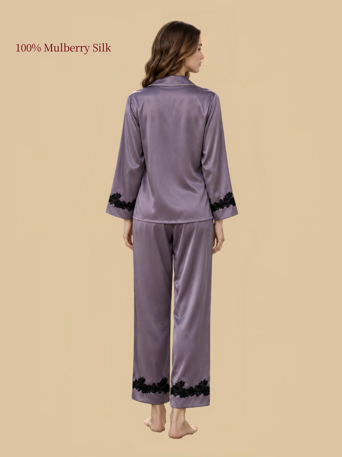 Back view of Twilight Purple silk sleepwear with relaxed long sleeves, straight-leg pants and black floral lace trim along the cuffs and pant hems.