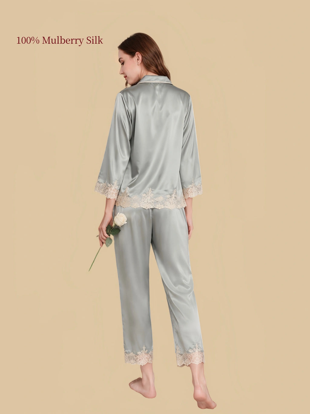 Rear view of Sky Blue silk pajamas with decorative lace along the lower shirt hem, sleeve cuffs and cropped pant hems
