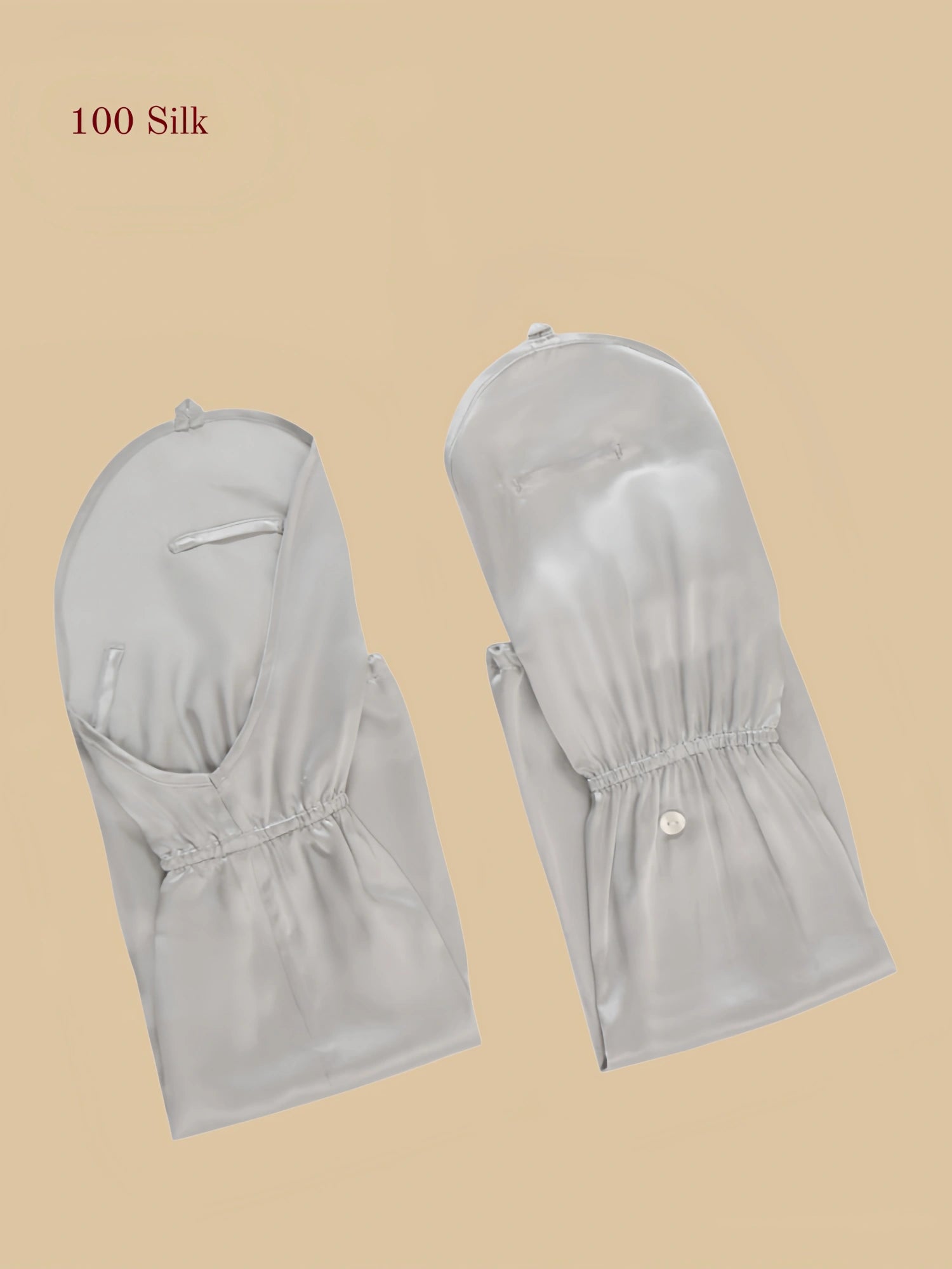 Silver gray 19MM mulberry silk arm sleeves laid flat with gathered cuff and button detail.