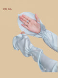 blue silk arm sleeves close-up showing finger opening, drawstring cuff, and buttoned convertible length.
