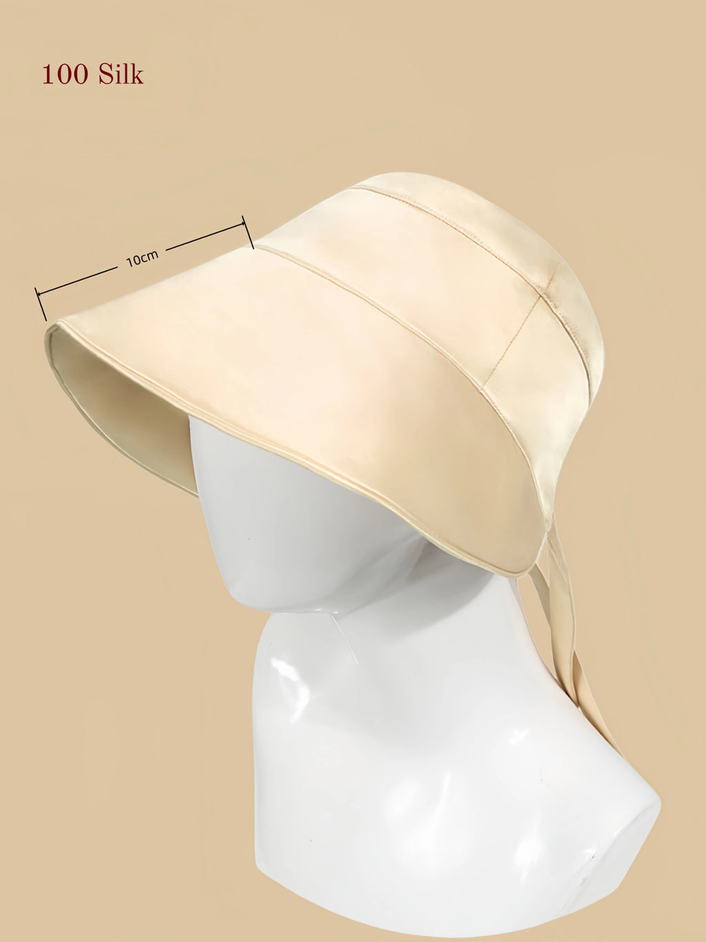 flowing gold mulberry silk outdoor sun hat on mannequin with a wide brim and back tie detail.