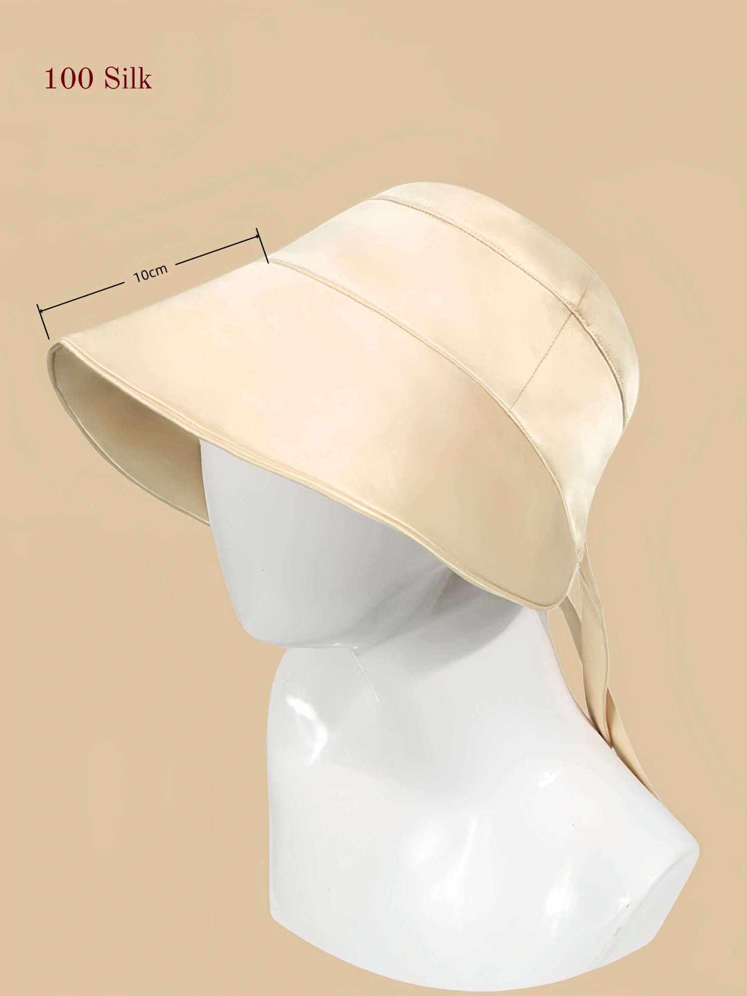 flowing gold mulberry silk outdoor sun hat on mannequin with a wide brim and back tie detail.