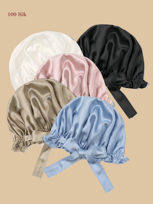 Multi-color silk shower caps arranged together in white, pink, champagne, light blue, and black