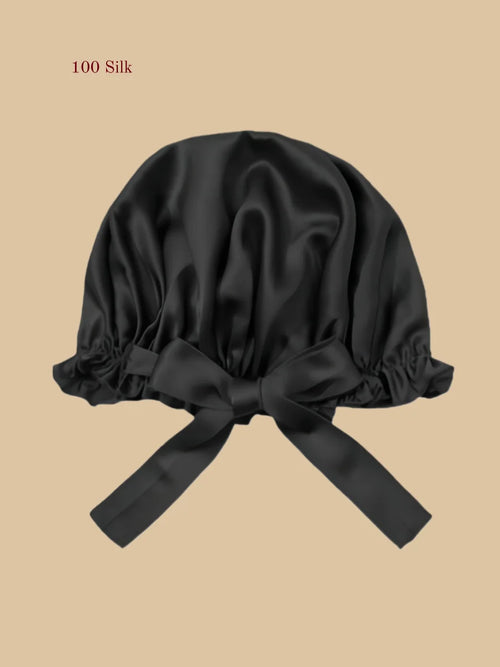 Black silk shower cap front view with gathered edge and adjustable ties