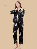Black 19mm two-piece silk loungewear front view with crane blossom print and contrast-piped collar