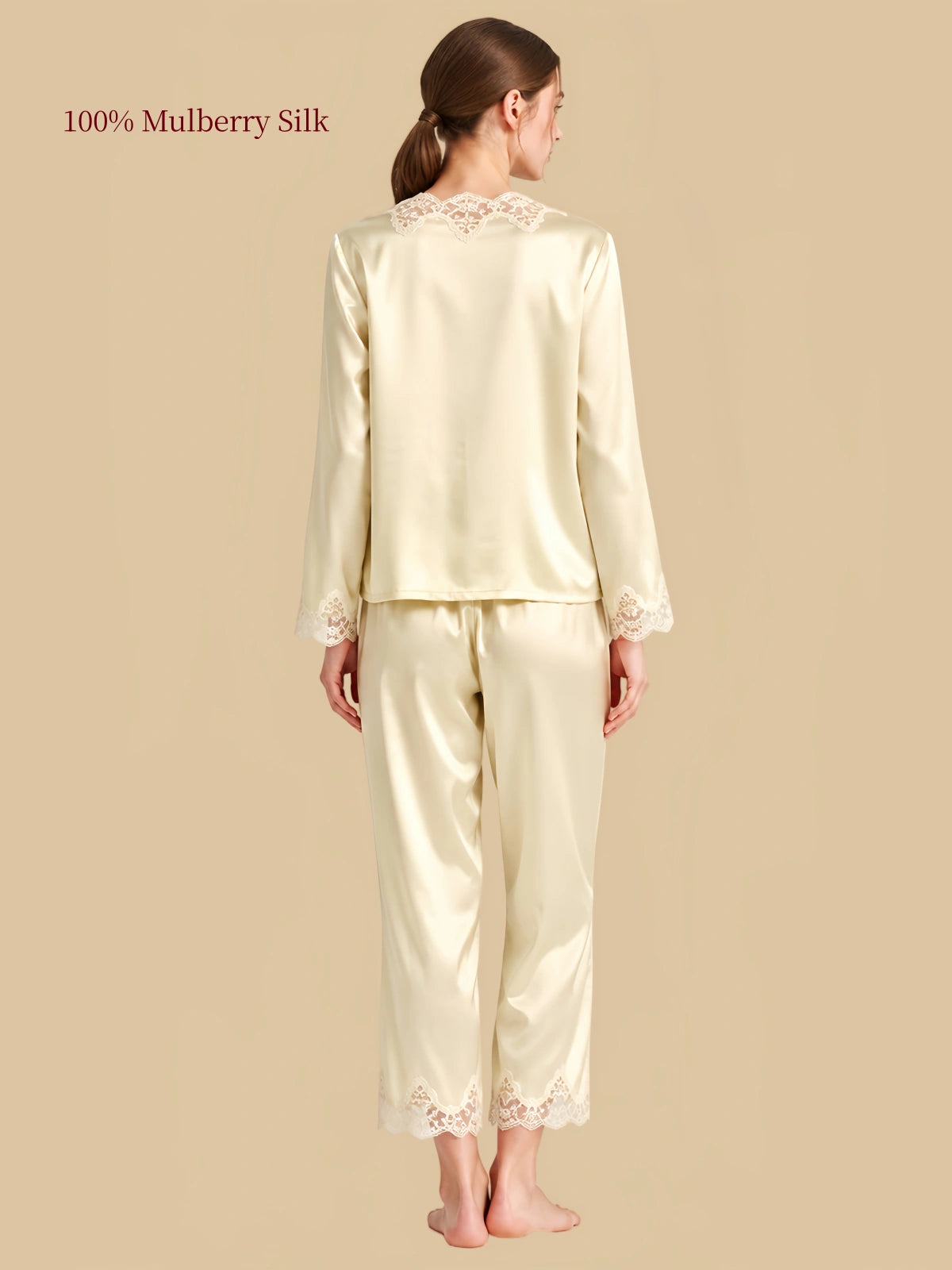 Back view of Coconut Milk silk sleepwear with lace at the upper neckline and scalloped lace trim along the pants.
