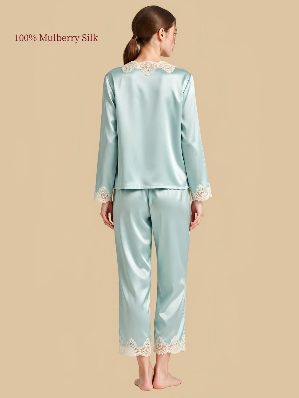 Back view of Hazy Blue silk sleepwear with floral lace at the rear neckline, relaxed long sleeves and scalloped lace pant hems.