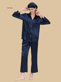 Navy 22 momme button-up pajamas front view with clean notched collar and matching silk cap shown
