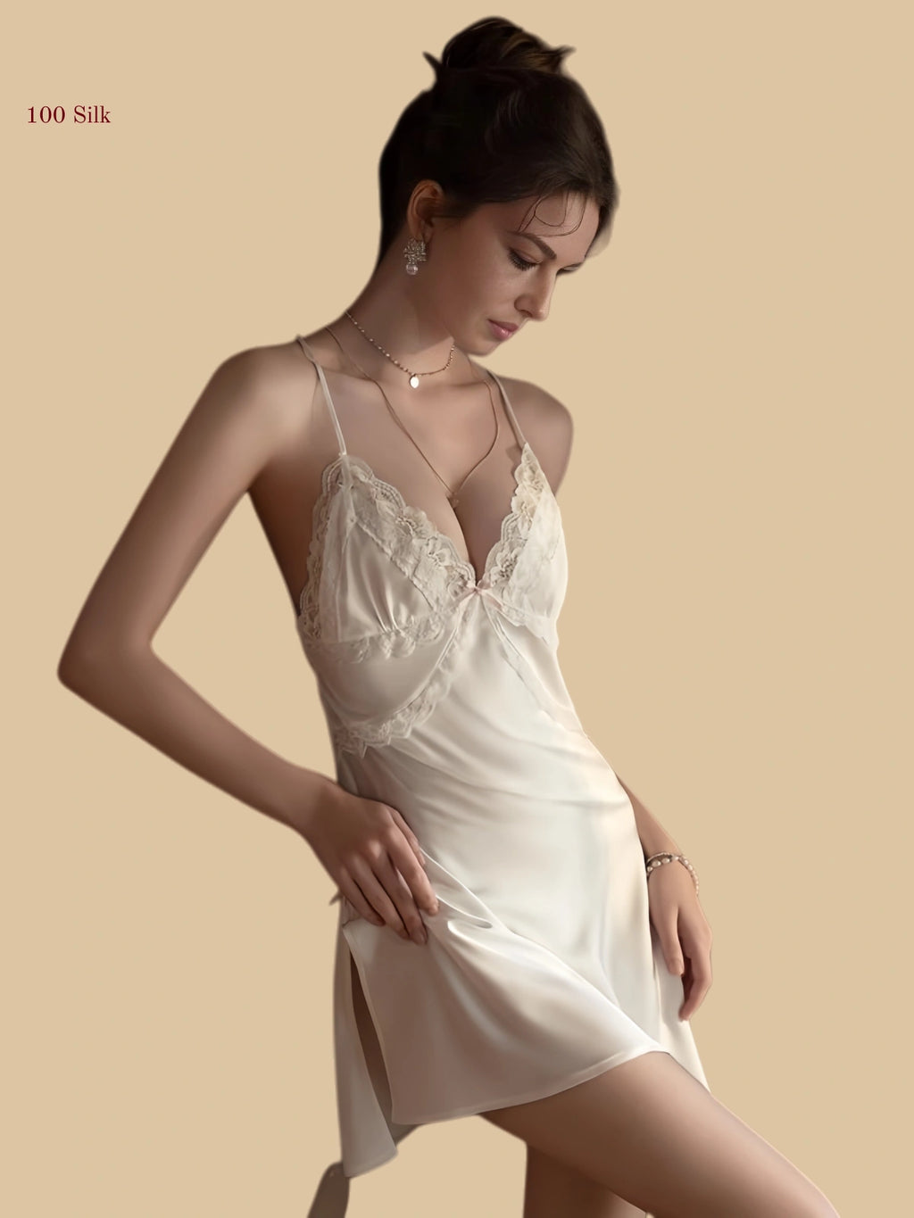 Front view of a 19mm white silk micro dress featuring a unique halter strap and centered bow with a lace-trimmed side slit.