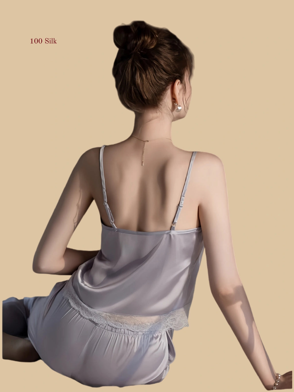 Light purple 19mm silk cami and pants seated view with lace neckline and relaxed straight-leg pants