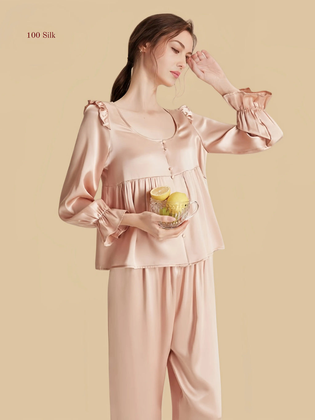 Pink 16.5mm peplum silk set front view with ruffle shoulders and full-length pants