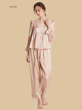 Pink 16.5mm peplum silk set front view with ruffle shoulders and full-length pants