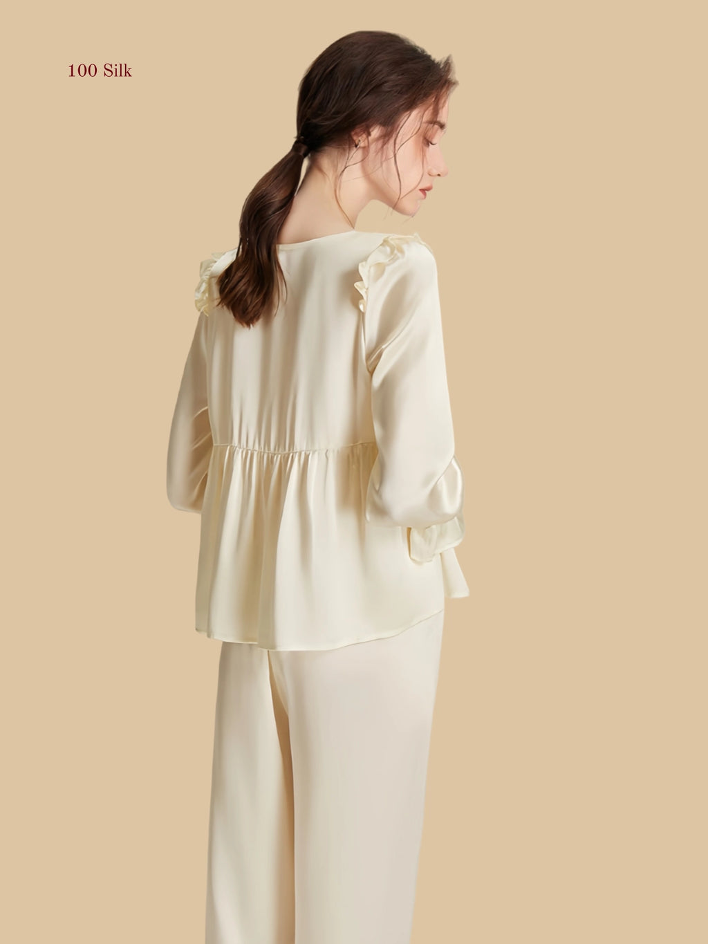 Off-white 16.5mm peplum silk set back view with soft peplum shape and long sleeves