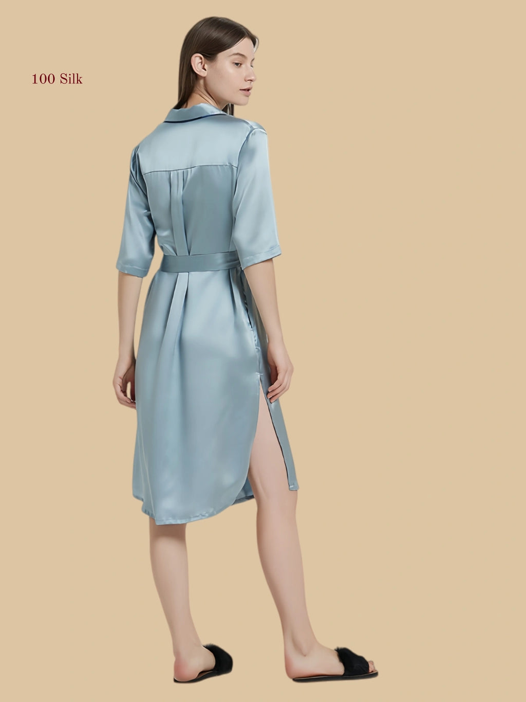 Rear view of the silk nightshirt showing the elegant U-shaped curved hem and flowing drape.