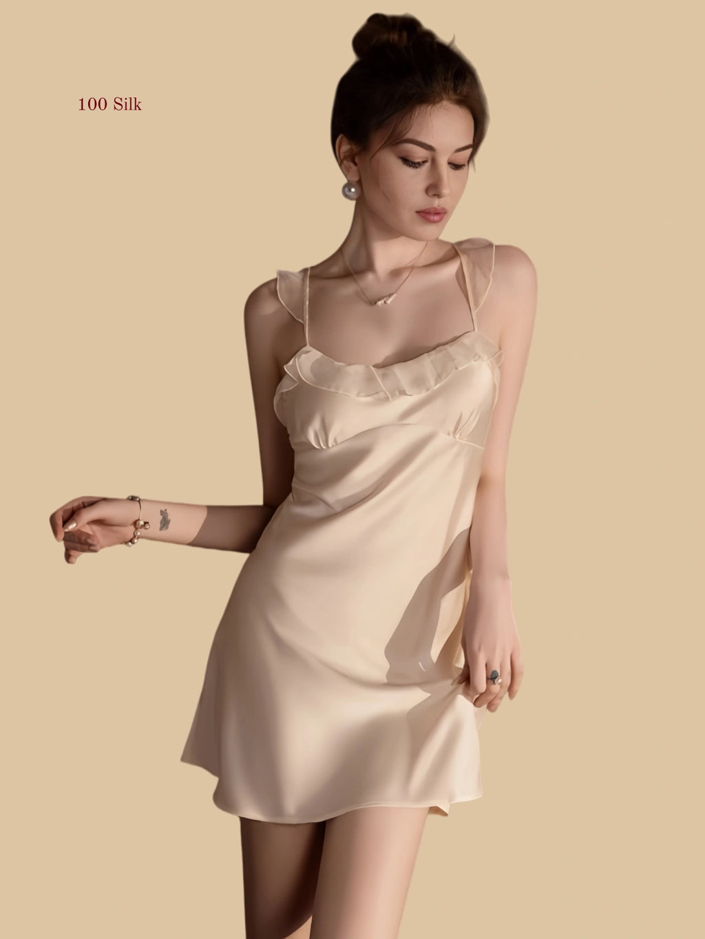 Front view of 19mm silk mini slip dress with ruffle neckline in apricot