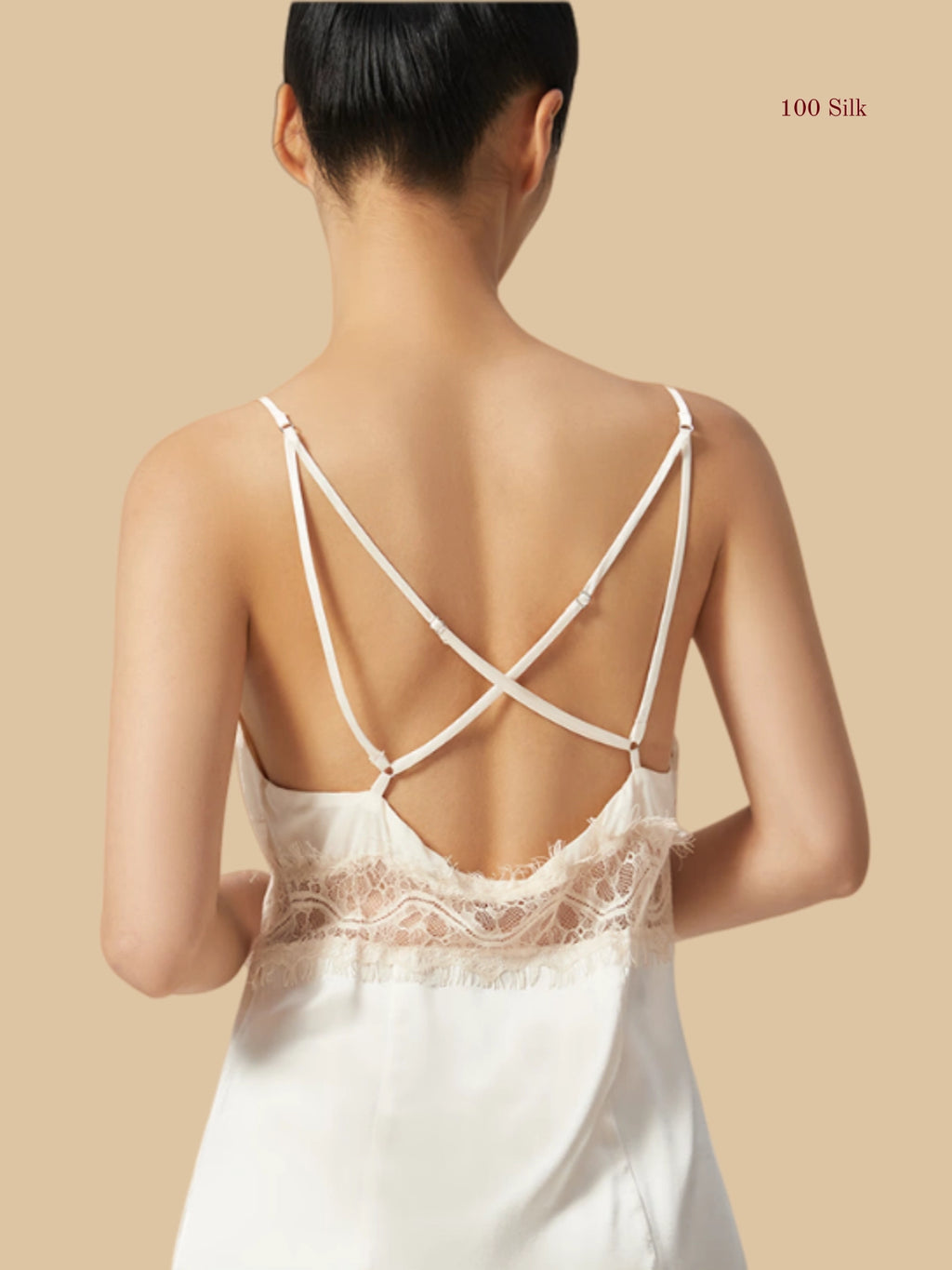 Back view of a white silk dress showcasing a deep open back design with elegant cross-over adjustable straps.