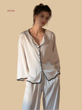 White 19mm soft-neck silk set front view with black contrast wave trim and relaxed trousers