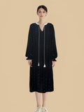 Black tassel-tie velvet dress front view with scattered star print and long neckline ties