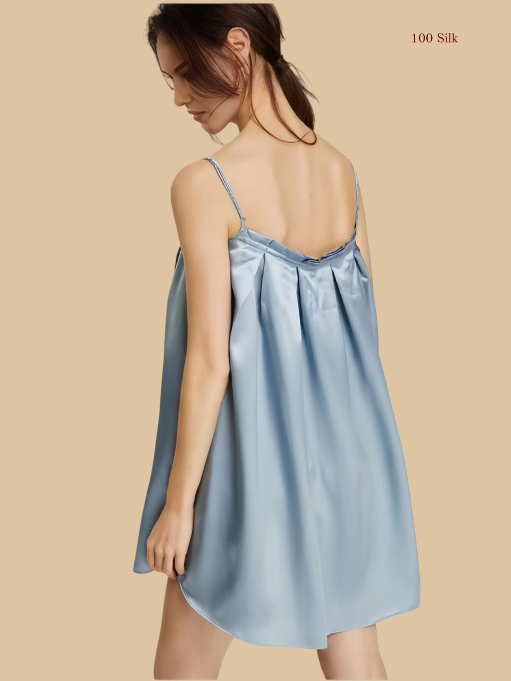 Back view of a misty blue silk pleated nightgown showcasing a relaxed fit and adjustable spaghetti straps.