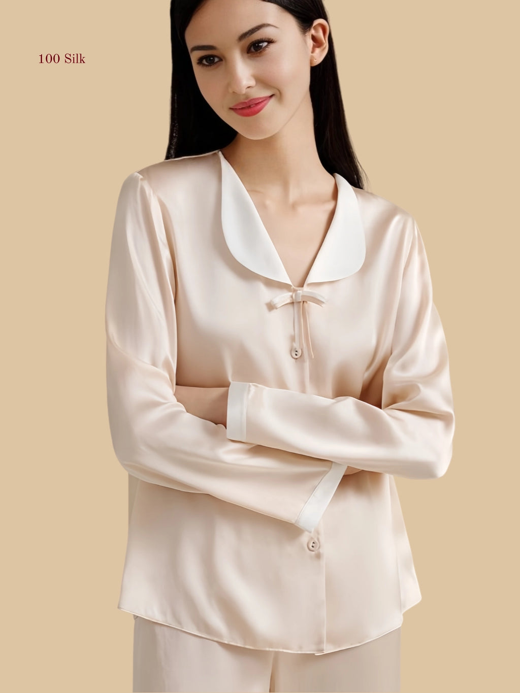 Detail view of 19mm silk set showing bow trim, contrast cuffs, buttons, and elastic waistband