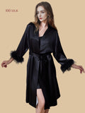 Onyx black 19mm silk wrap lounge set front view with feather-trim cuffs and matching short chemise