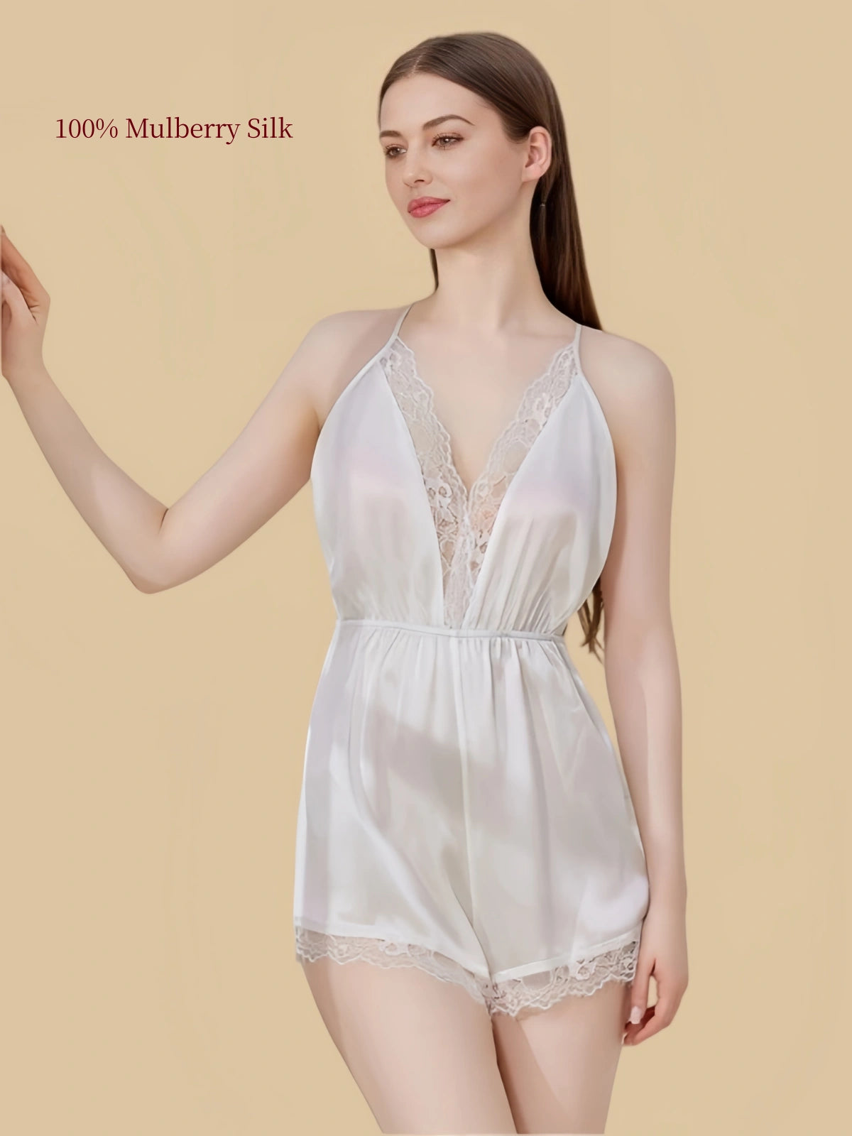 Angled front view of the White silk romper with floral lace neckline and elastic waist