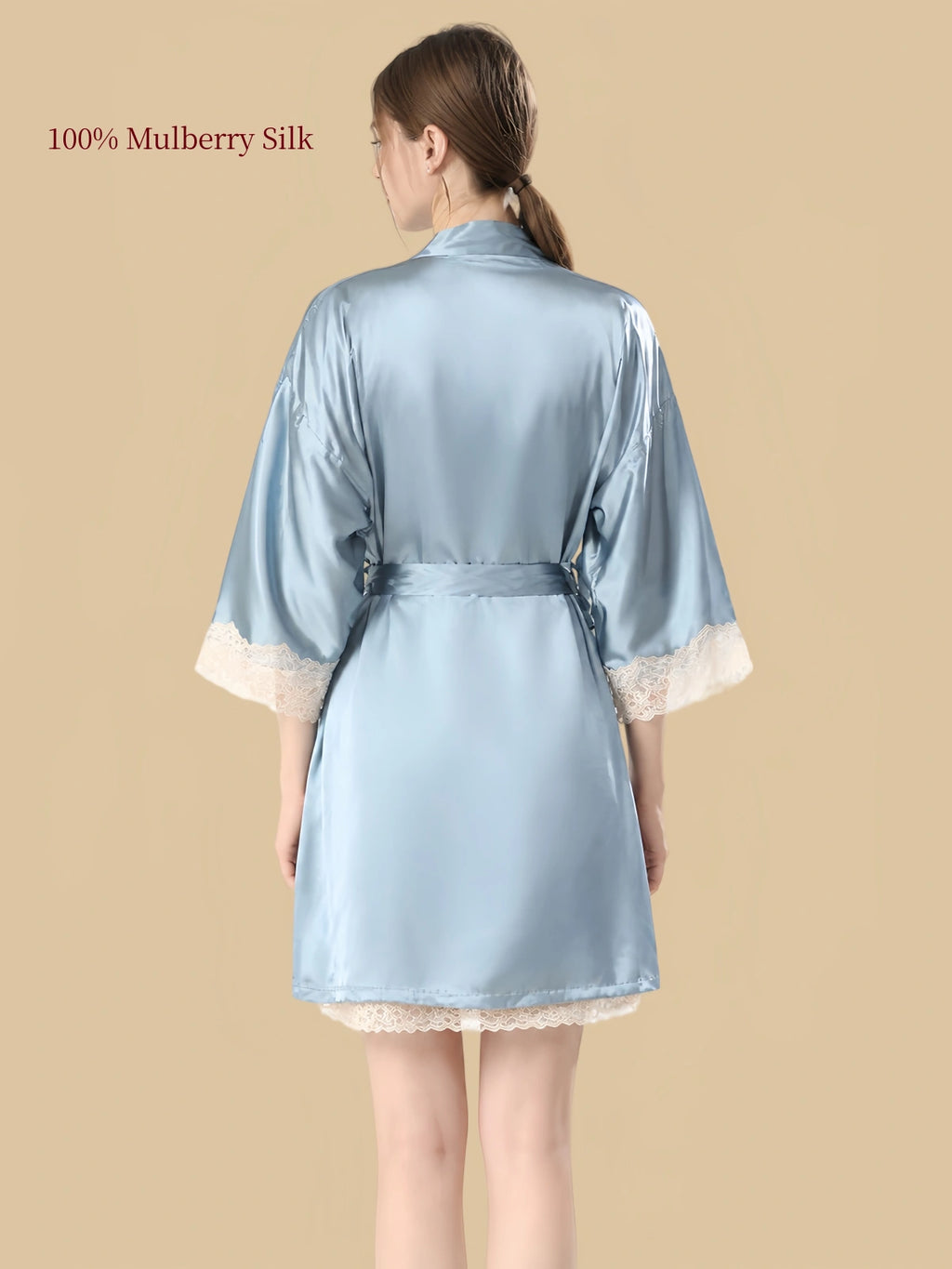 Back view of Clear Sky Blue silk robe featuring a relaxed silhouette, waist tie and ivory floral lace sleeve cuffs.